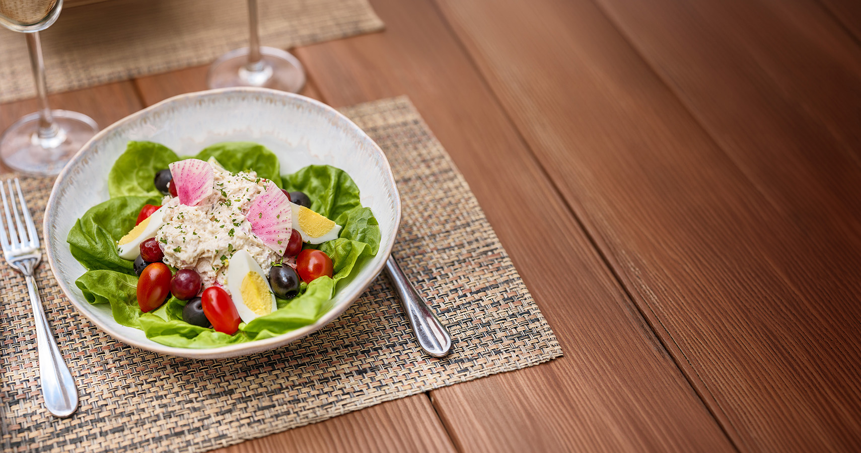 a bowl of salad on a place mat