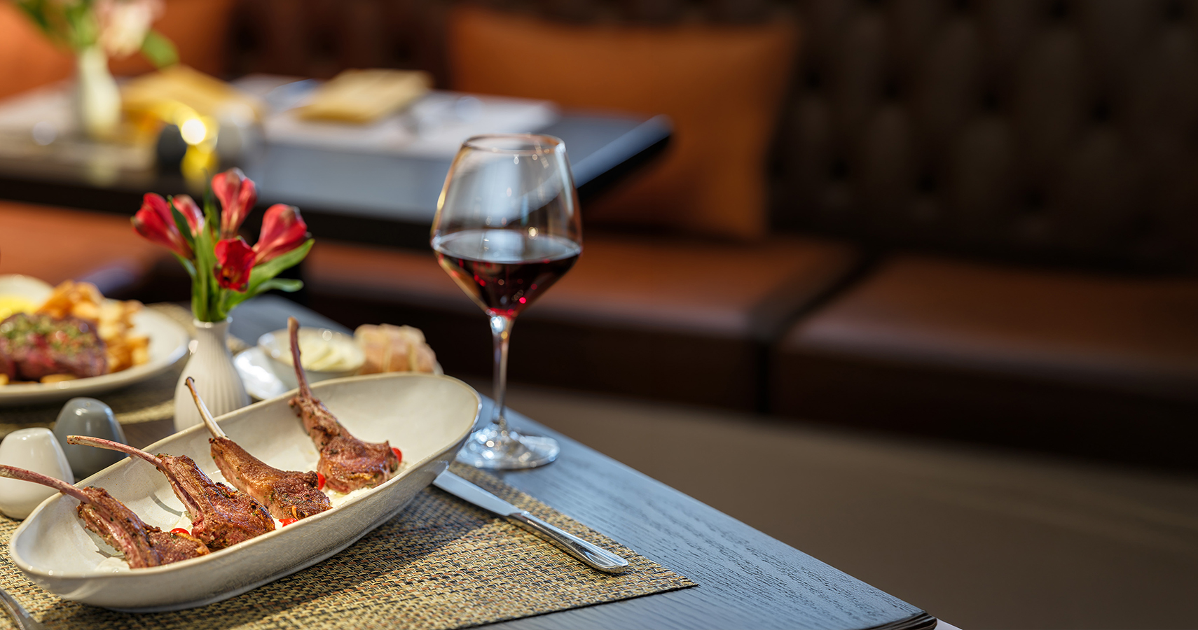 a plate of meat and a glass of wine