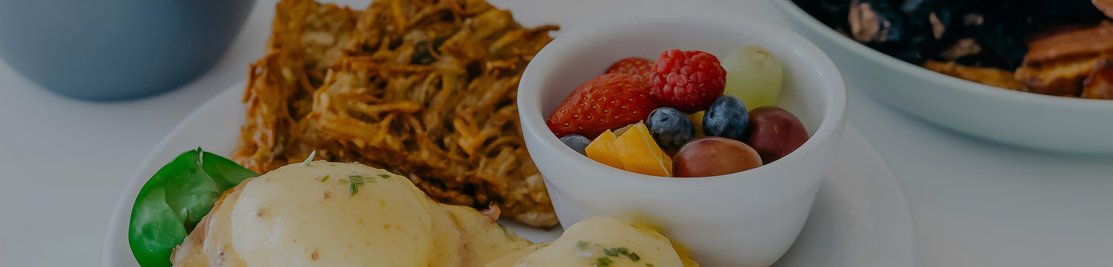 a bowl of fruit and a plate of food