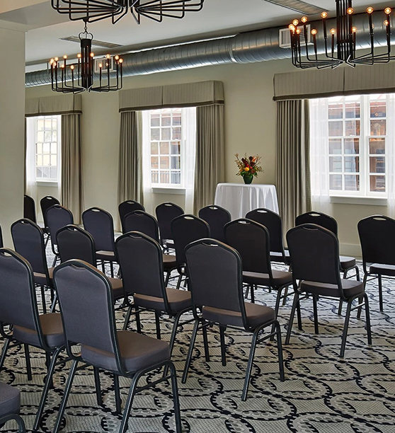 a room with chairs and chandeliers