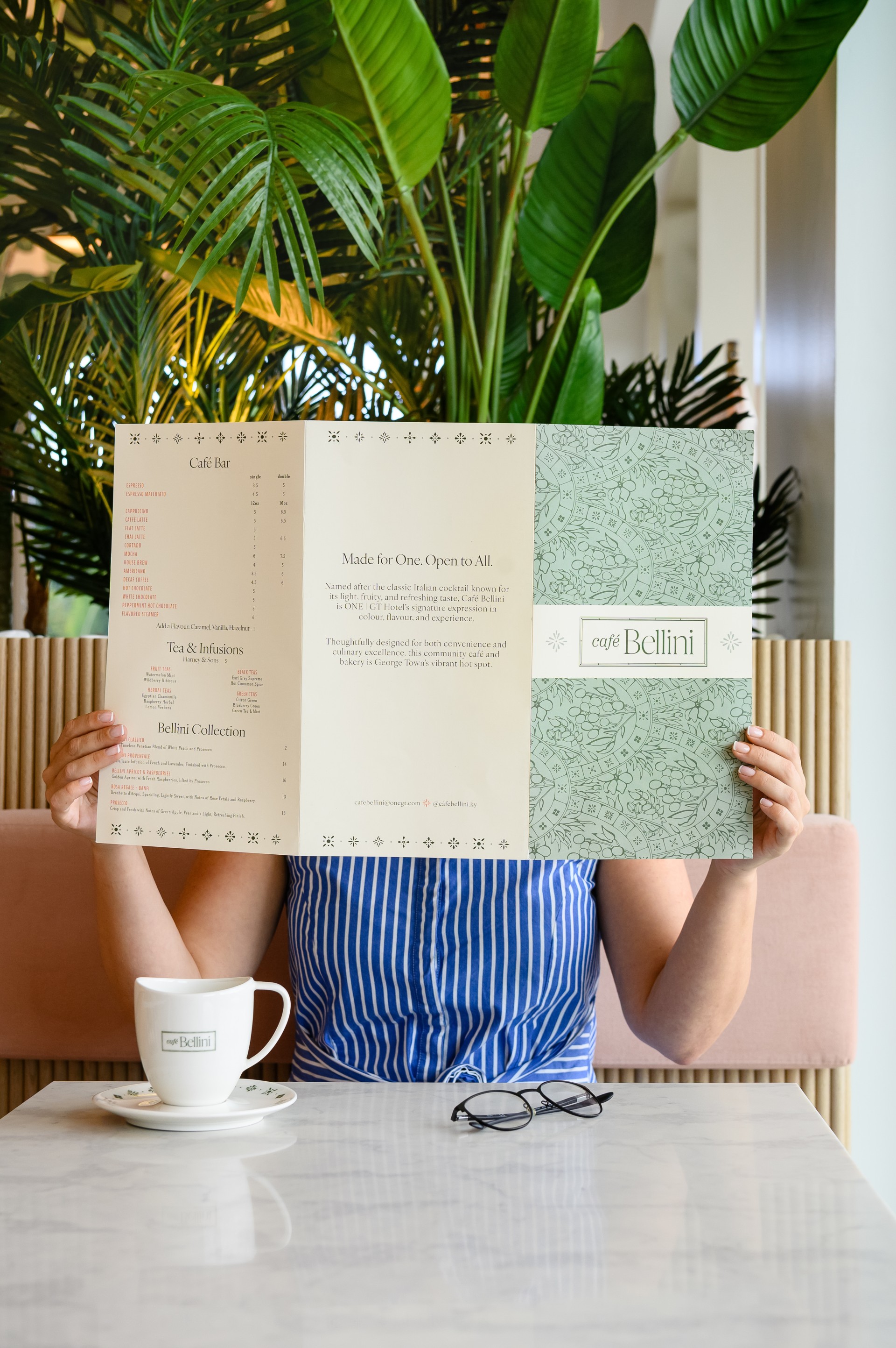 a person holding a menu in front of their face