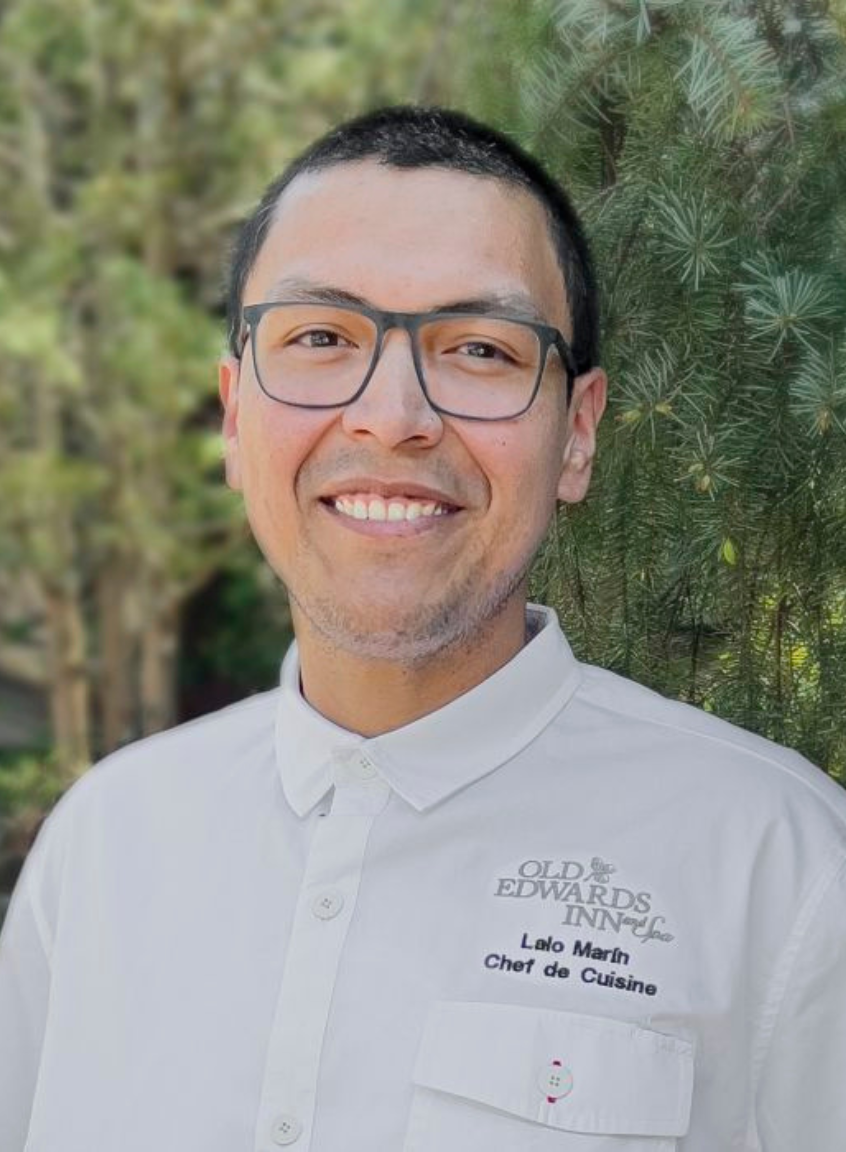 a man wearing glasses and a white shirt