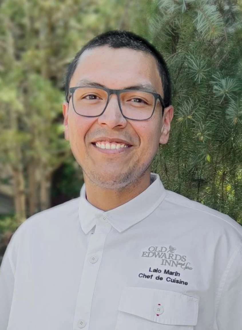 a man wearing glasses and a white shirt