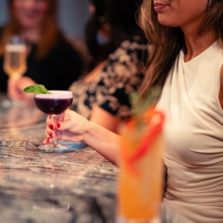 a woman holding a drink