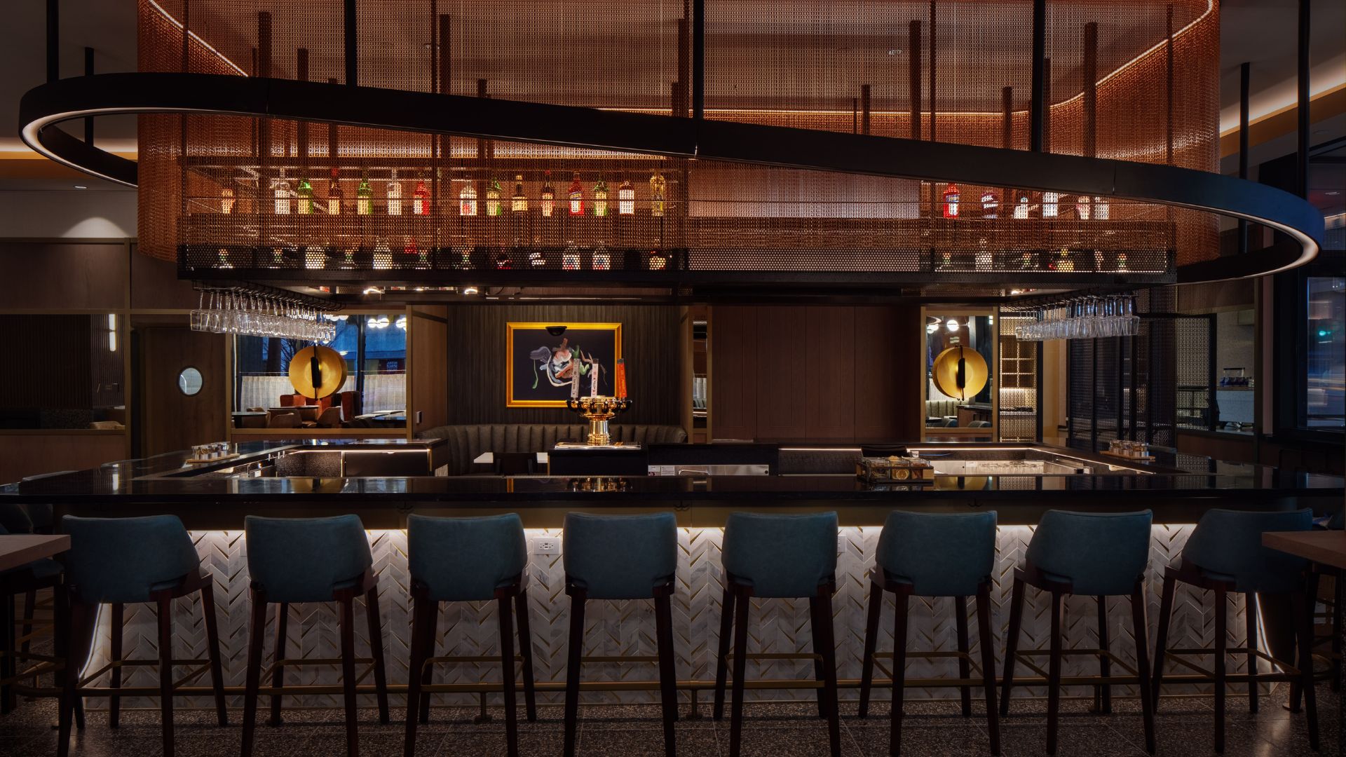 a bar with chairs in front of a wall