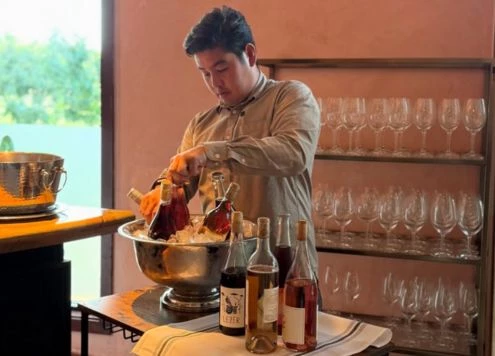 a man pouring wine into a bowl