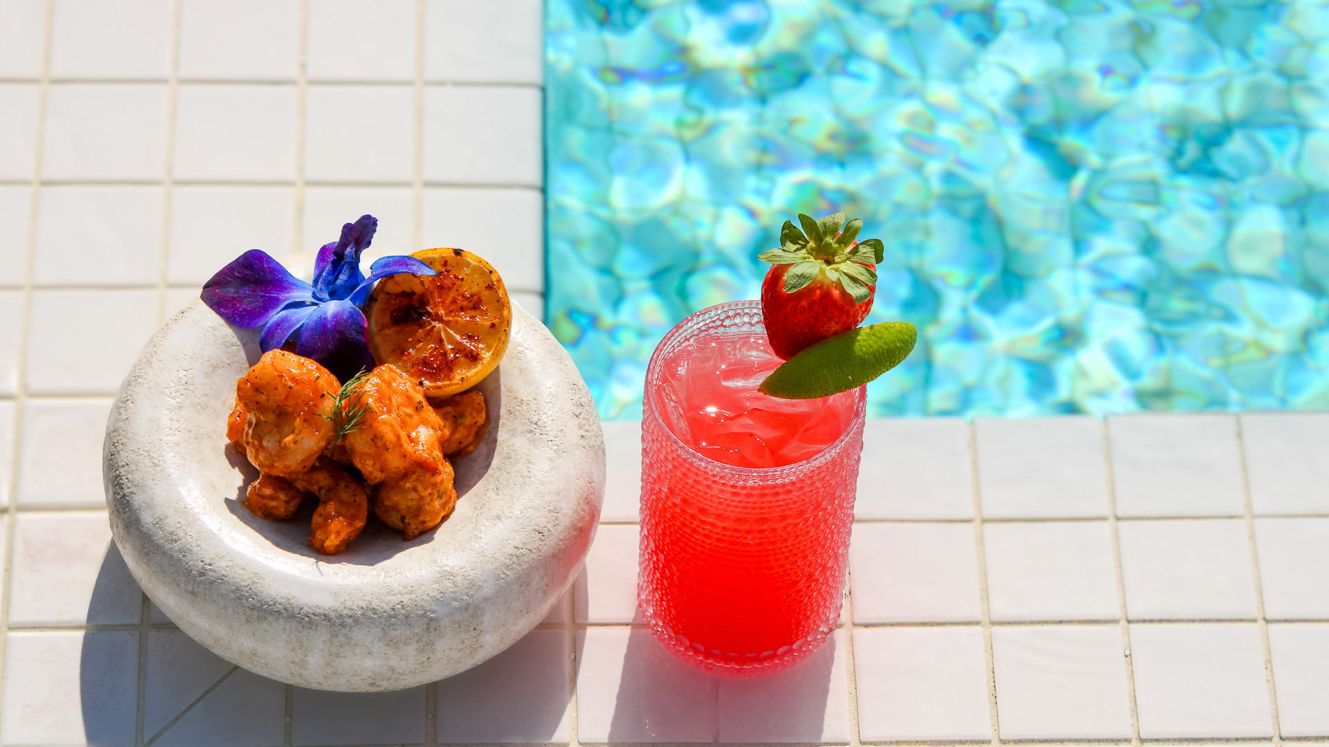 a bowl of food next to a drink