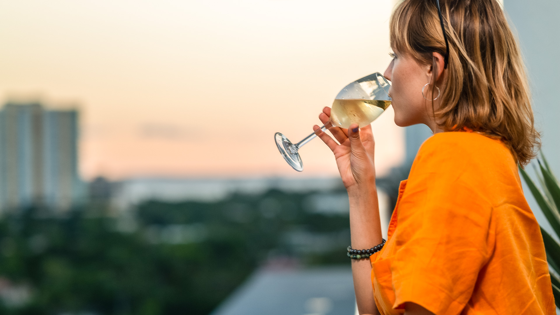 a woman drinking from a glass