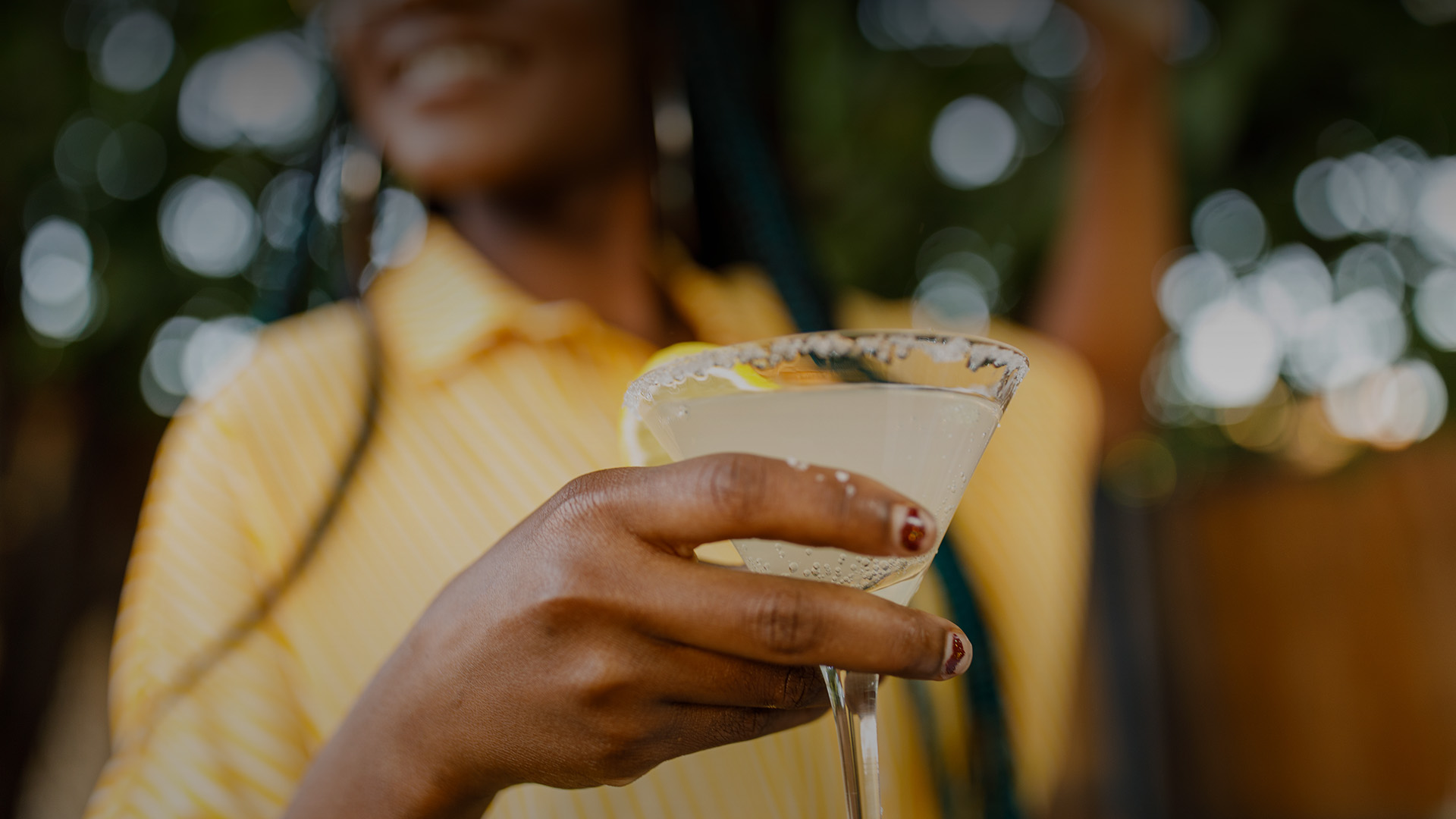 a woman holding a martini glass