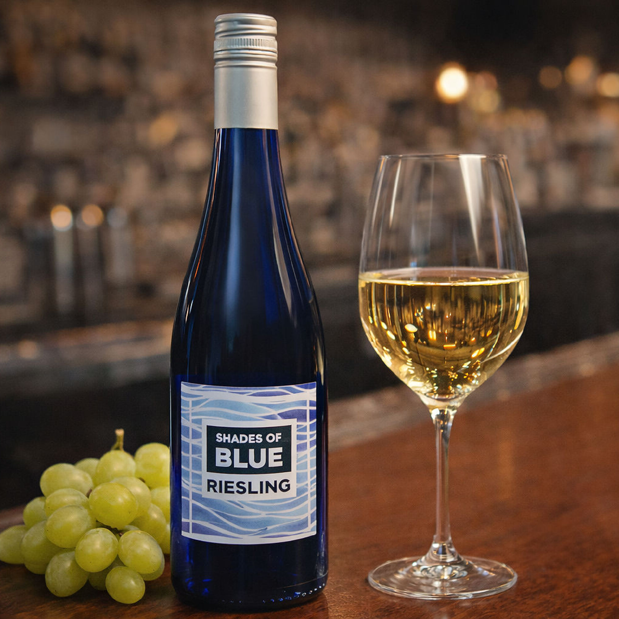 a bottle of wine next to a glass of wine