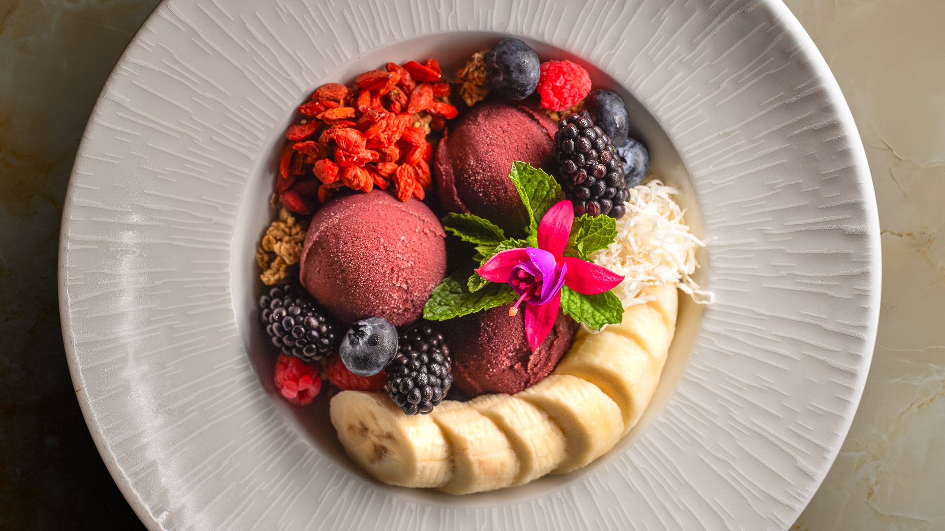 a bowl of fruit and ice cream
