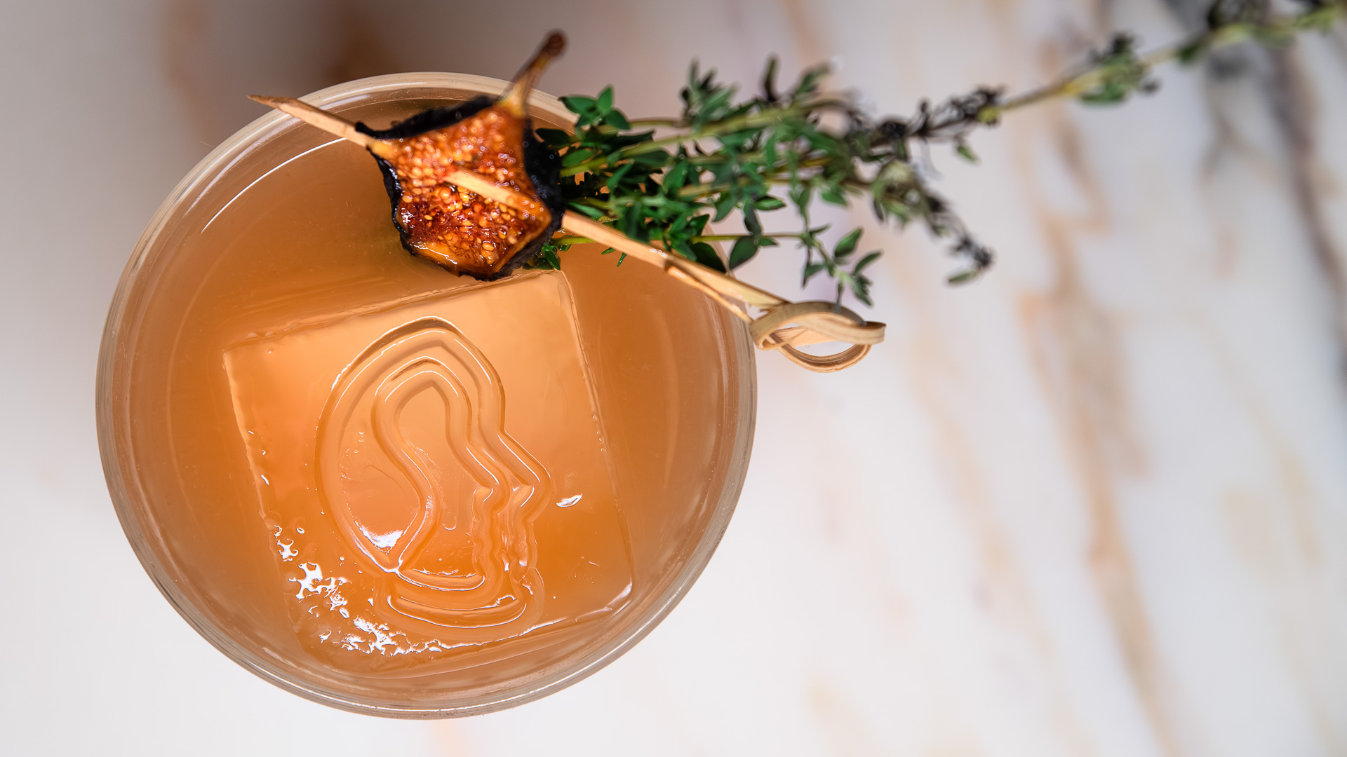 a glass with liquid and a plant