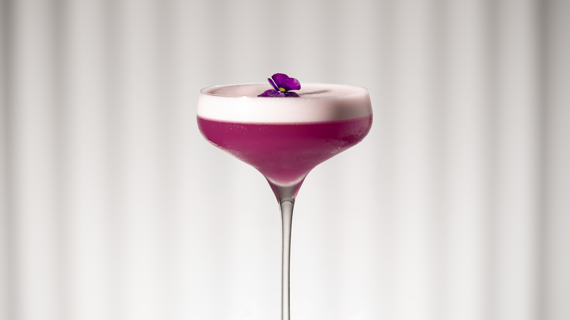 a purple drink with a flower on top