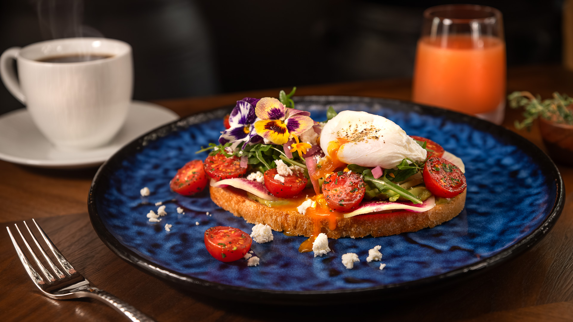 a plate of food with flowers and a drink