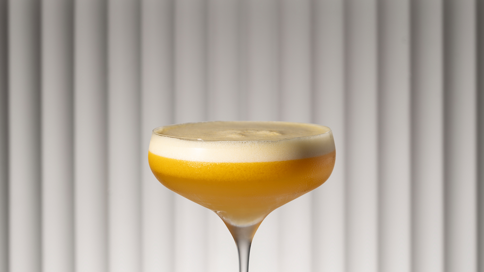 a glass with a yellow liquid in it