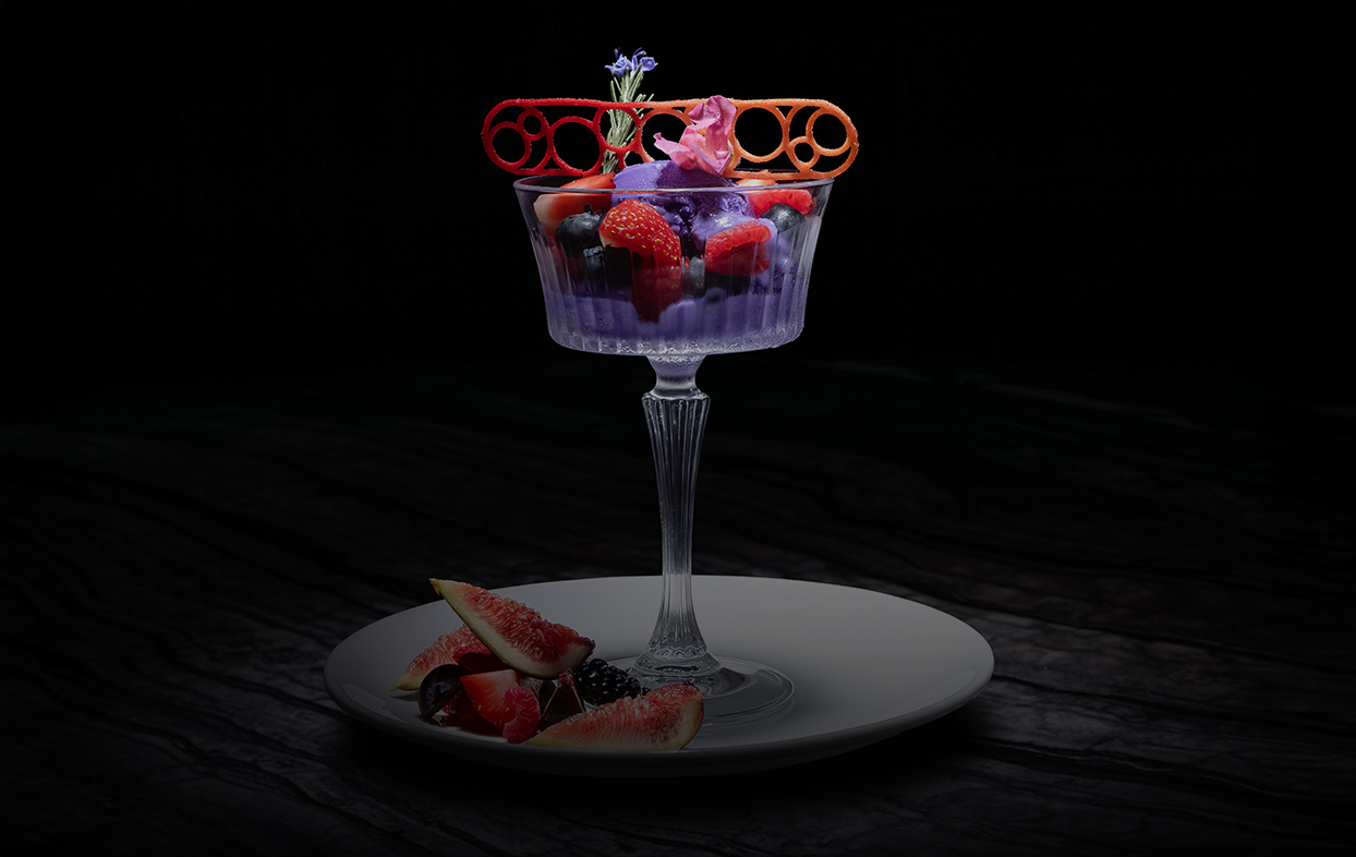 a glass of fruit on a plate