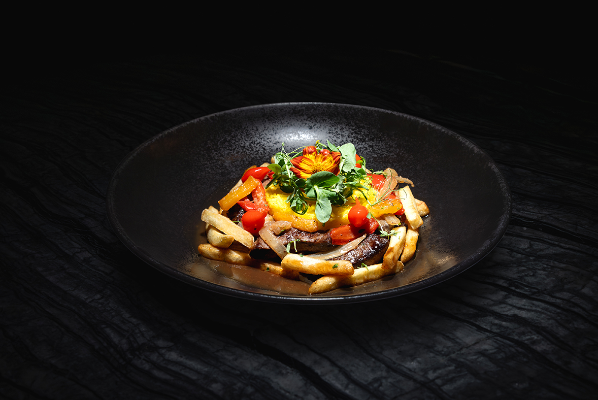a plate of food on a black surface