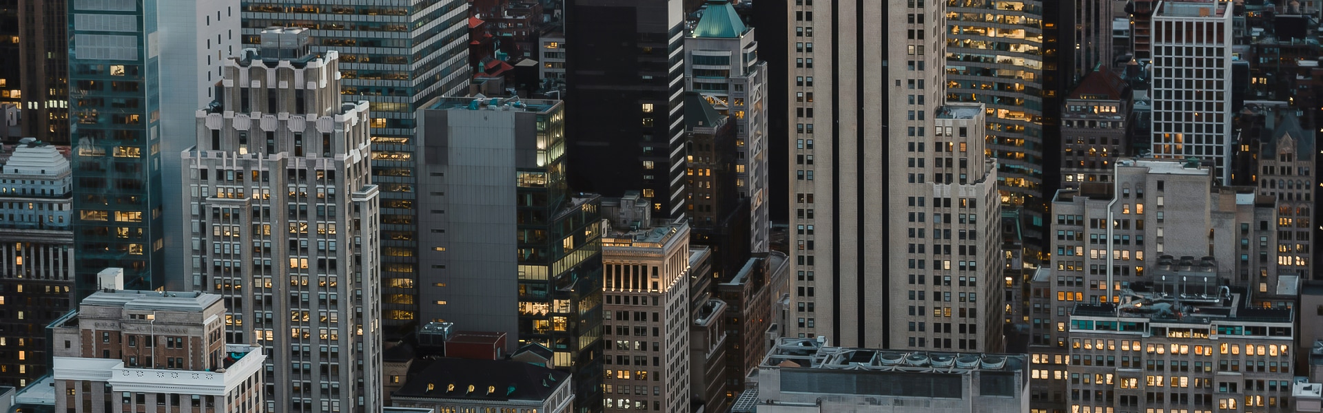 a group of tall buildings with lights on