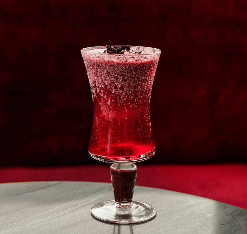 a glass with a drink on a table