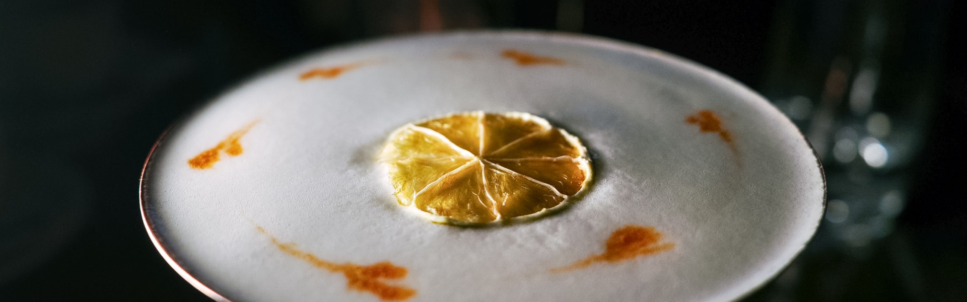 a slice of orange on a white surface