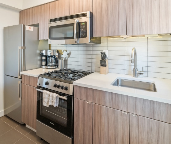 a kitchen with a stainless steel stove and microwave