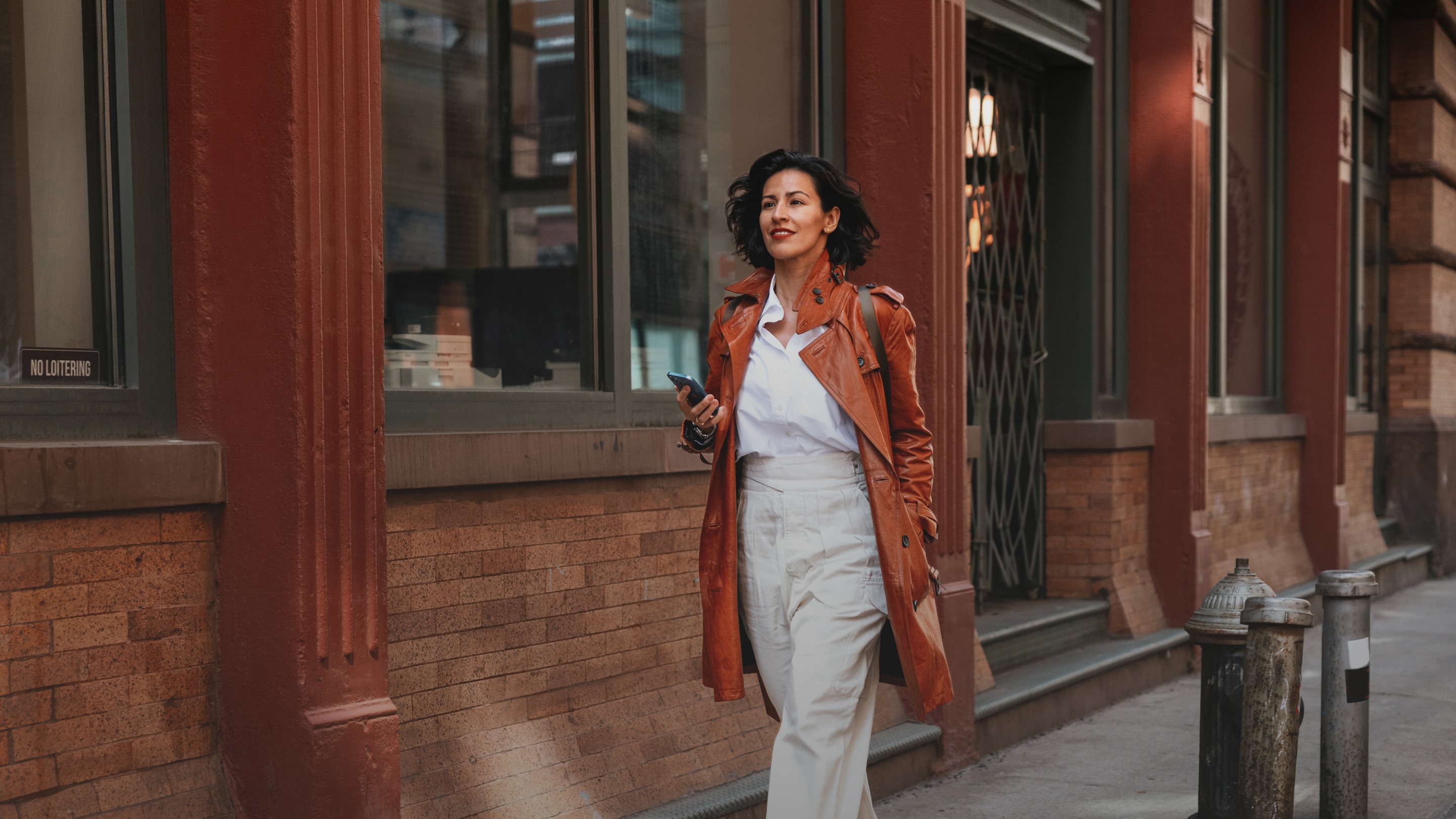 a woman walking on a sidewalk