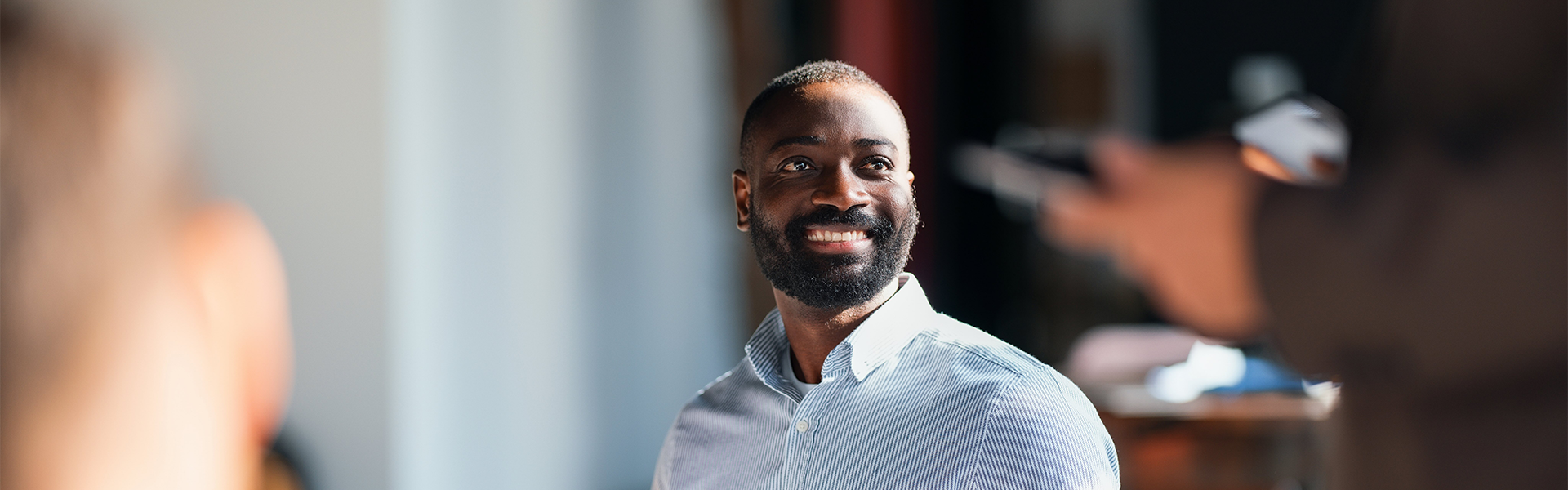 a man with a beard smiling
