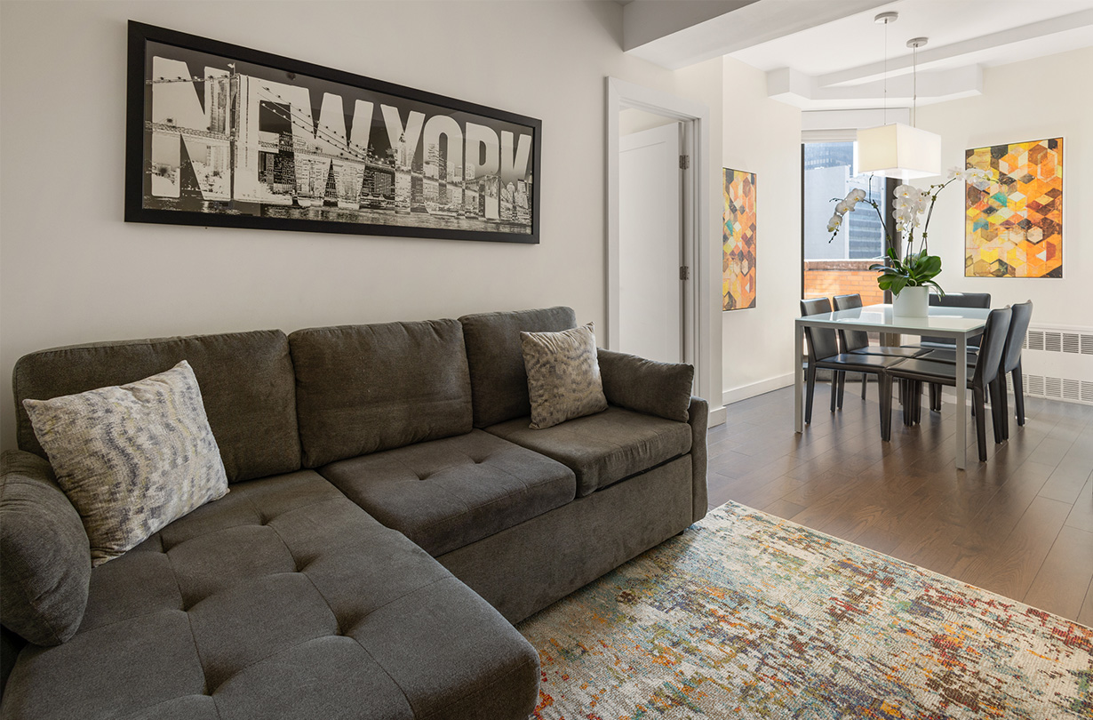 a living room with a couch and dining table