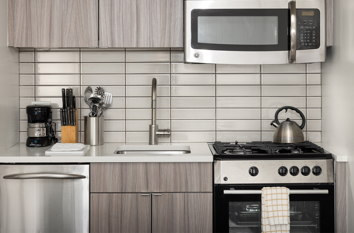 a kitchen with a stove and microwave