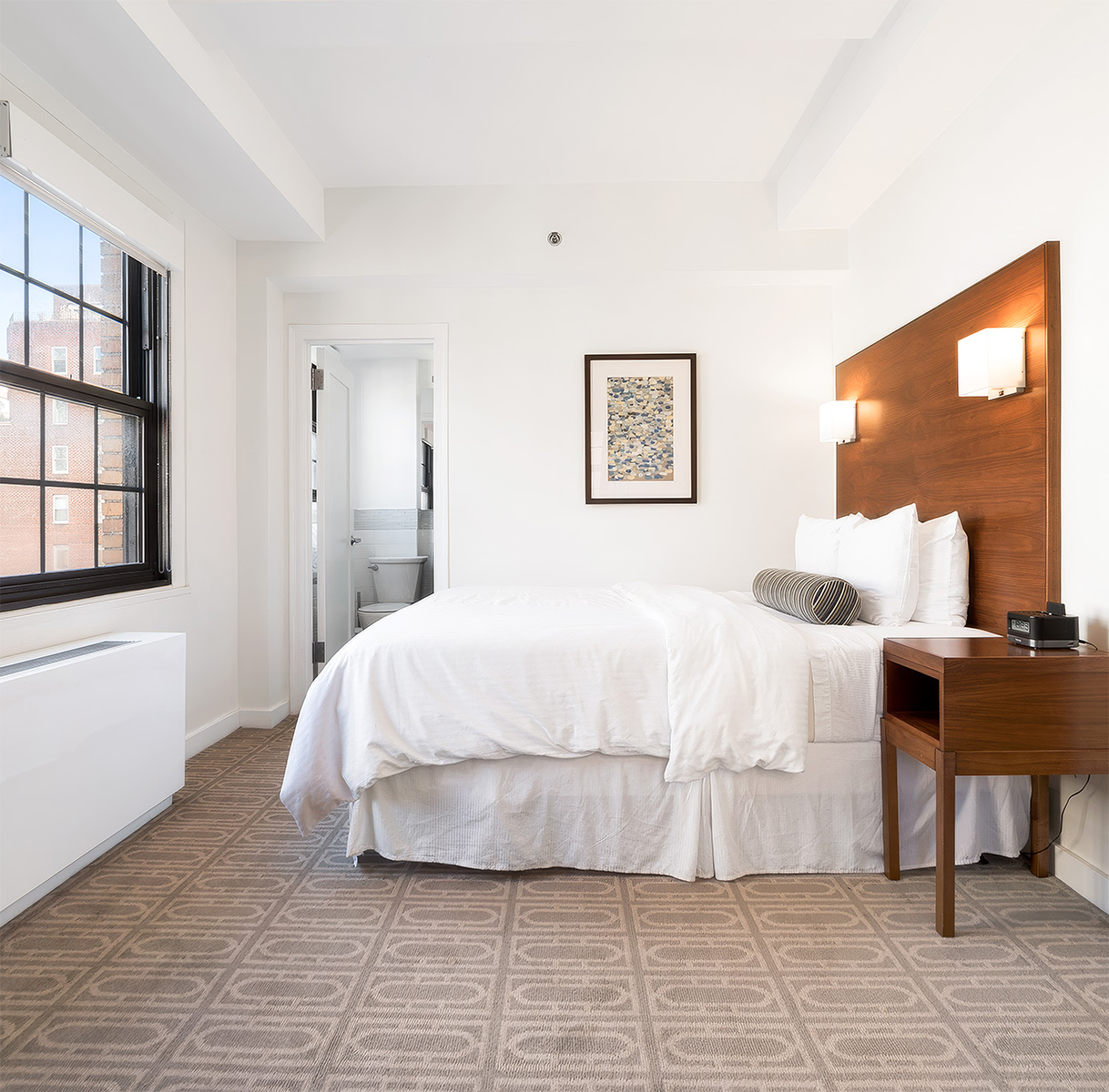 a bedroom with a bed and a table