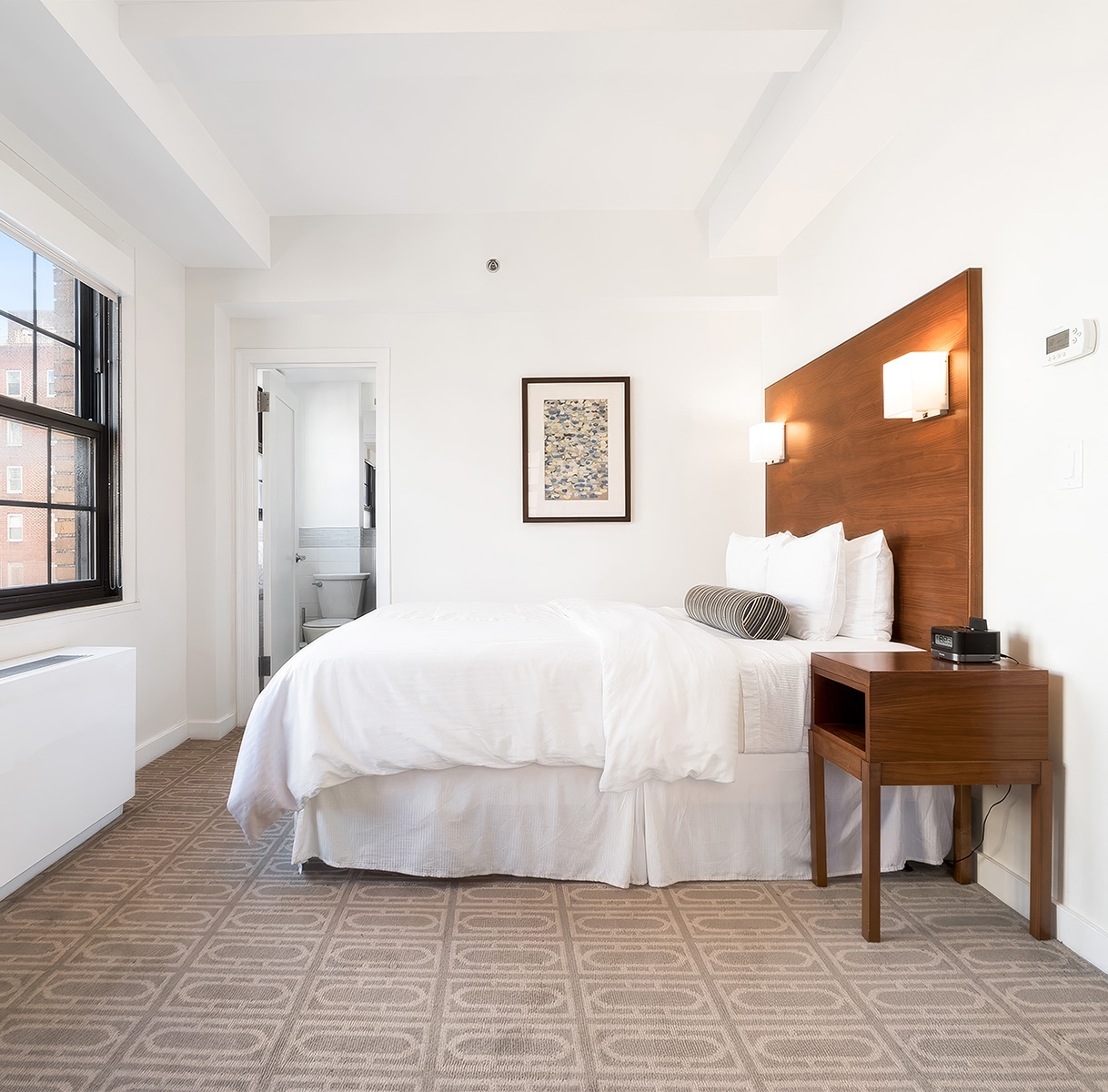 a bedroom with a bed and a table