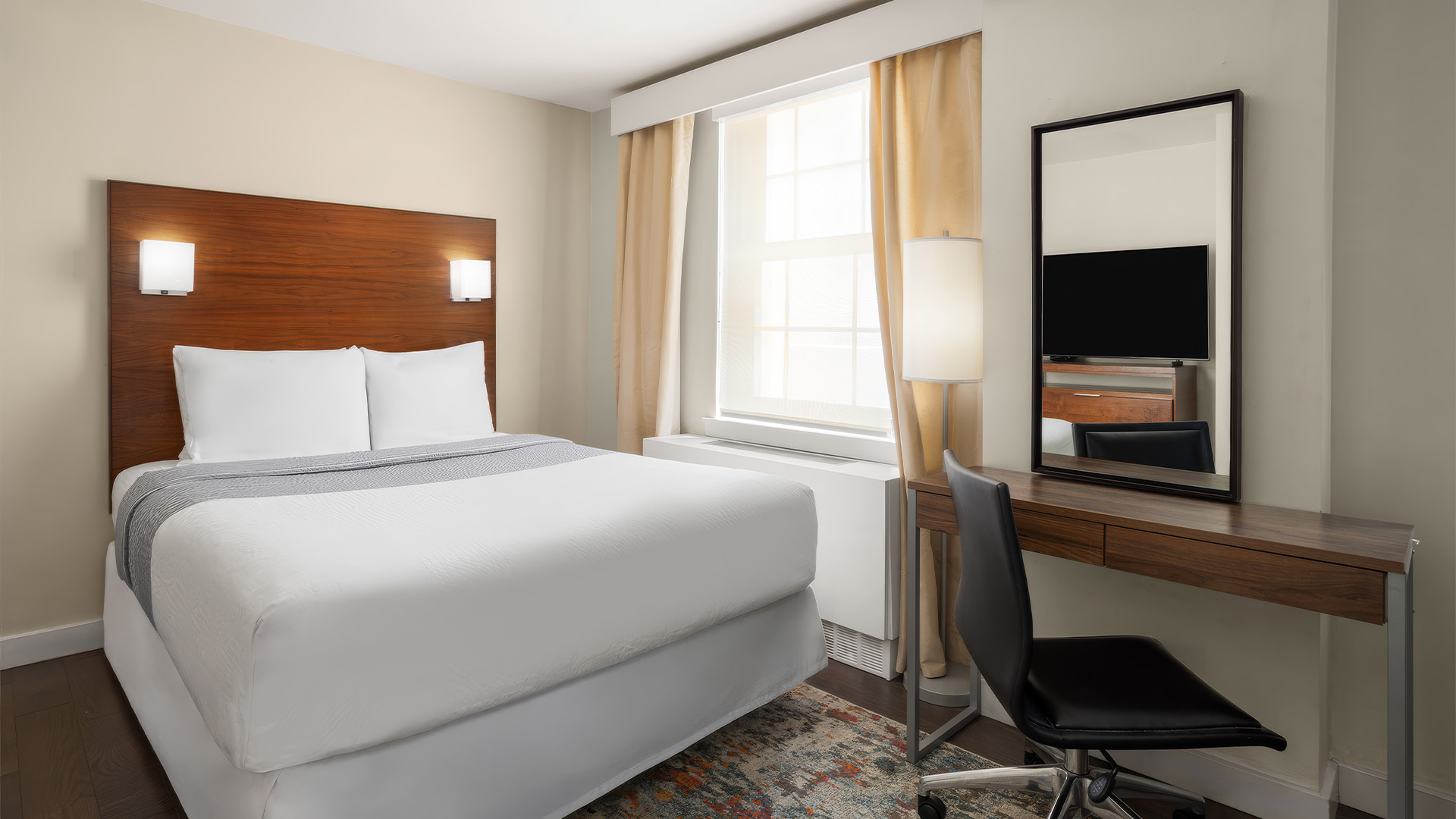 a room with a bed and a mirror
