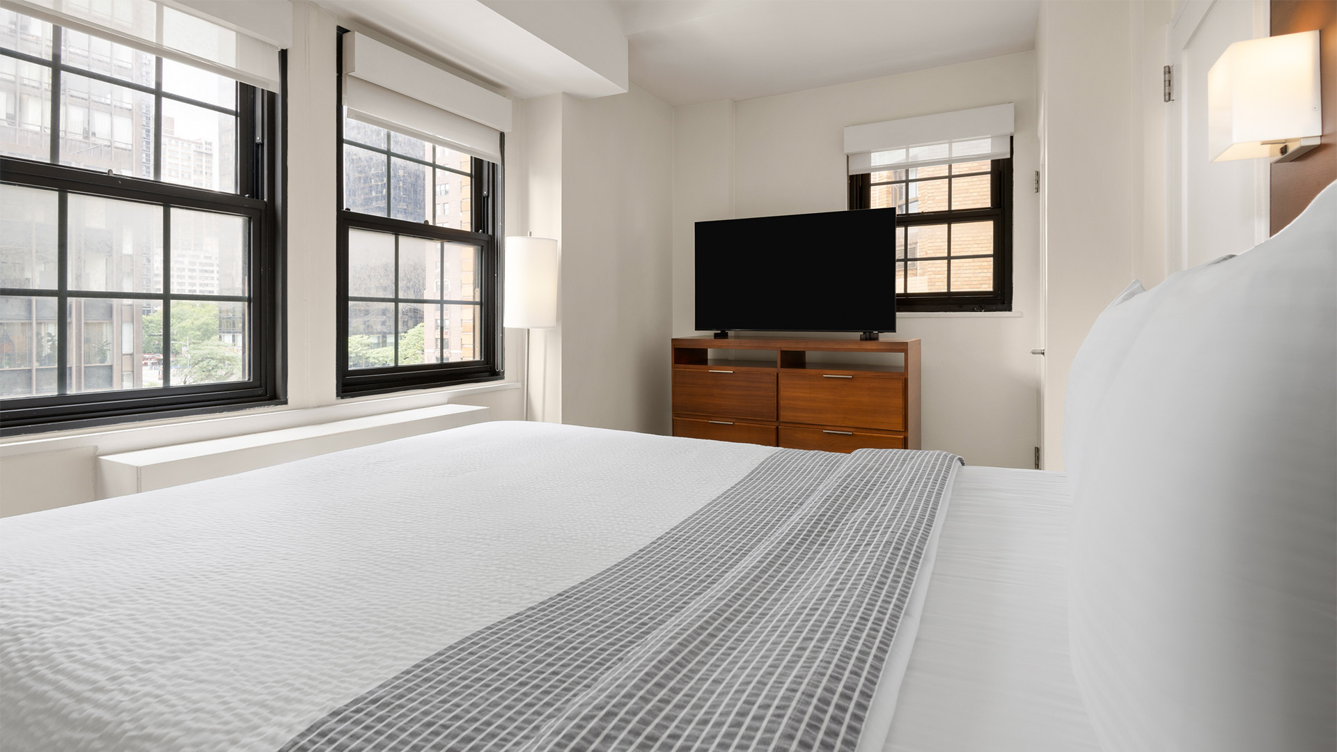 a bedroom with a tv and a dresser