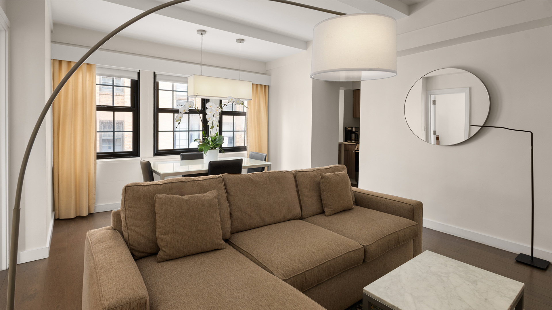 a living room with a couch and a dining table