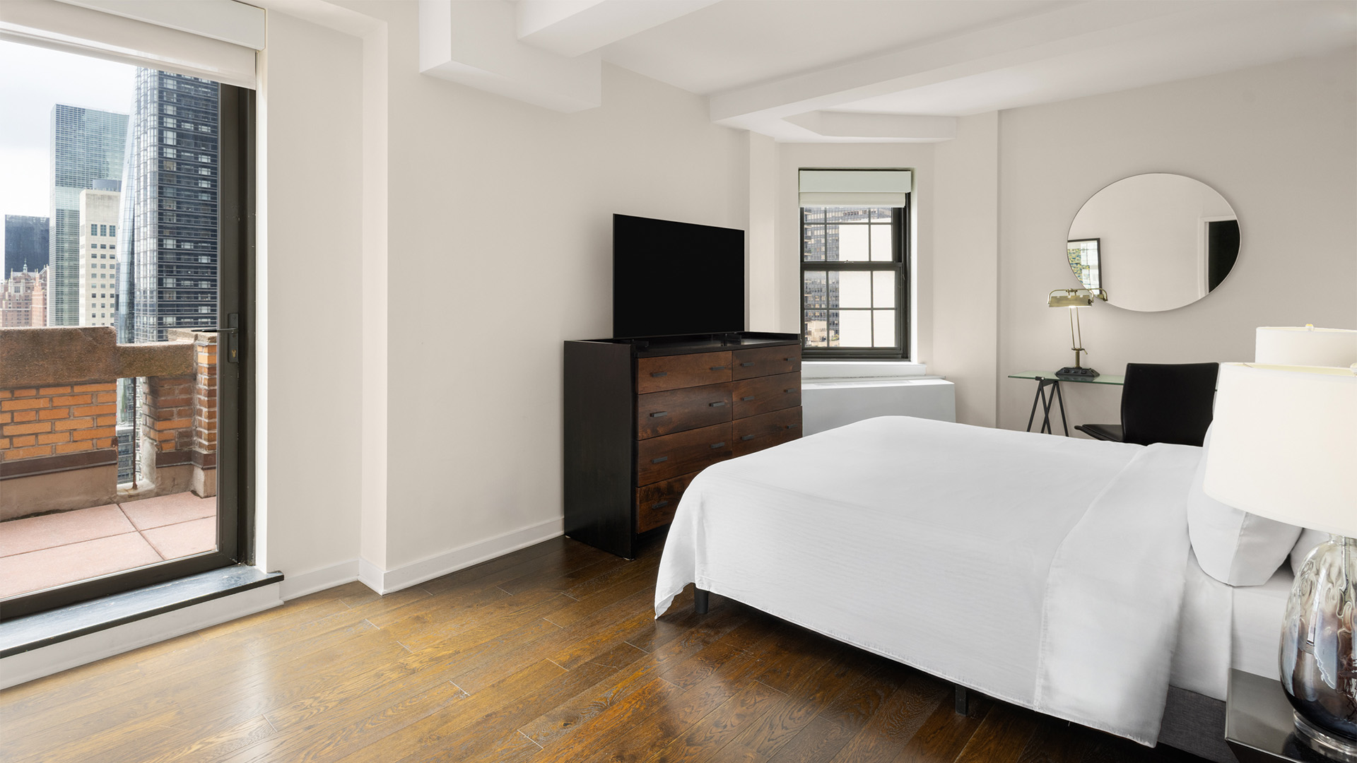 a bedroom with a tv and a dresser
