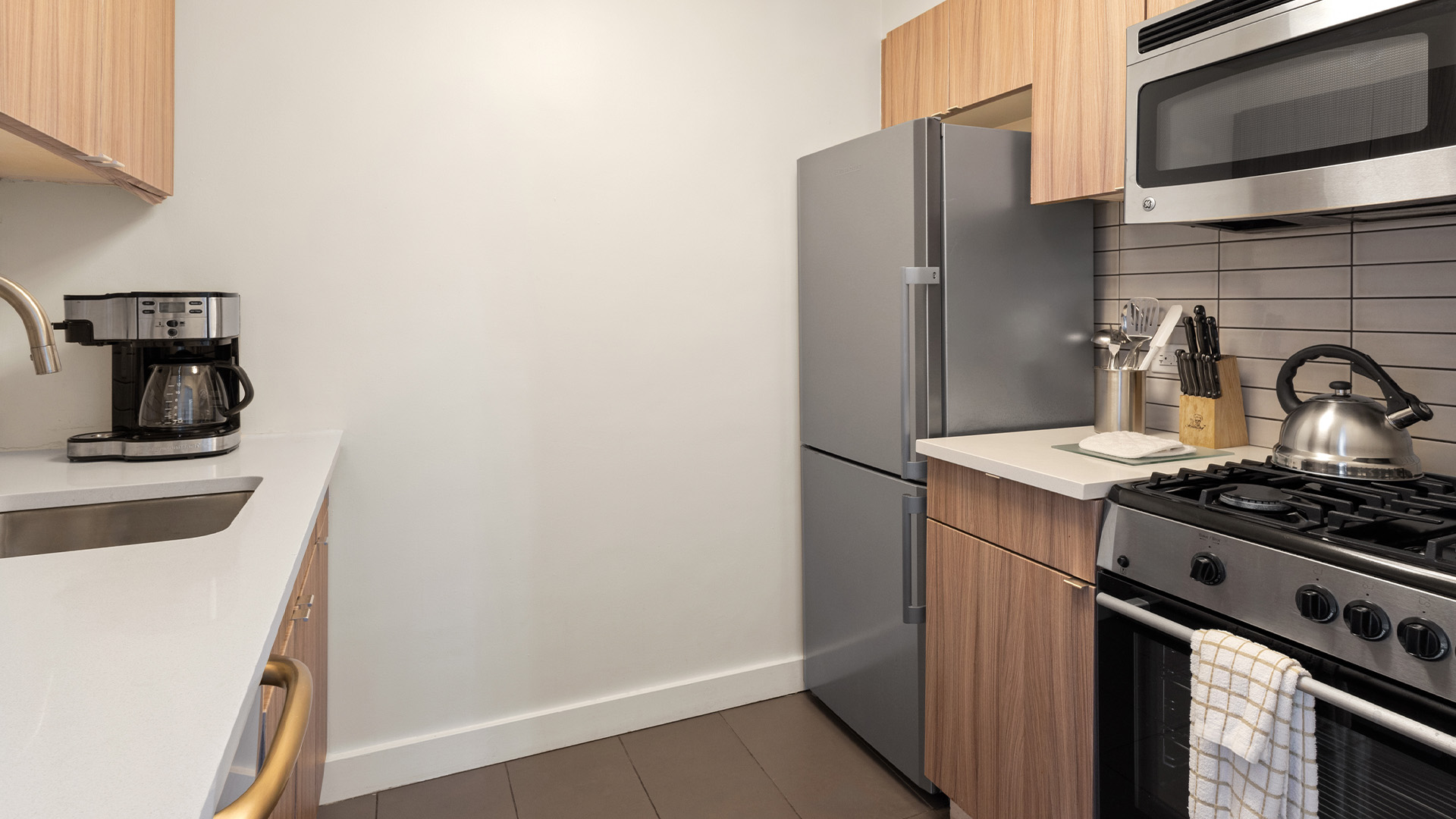 a kitchen with a refrigerator and a stove