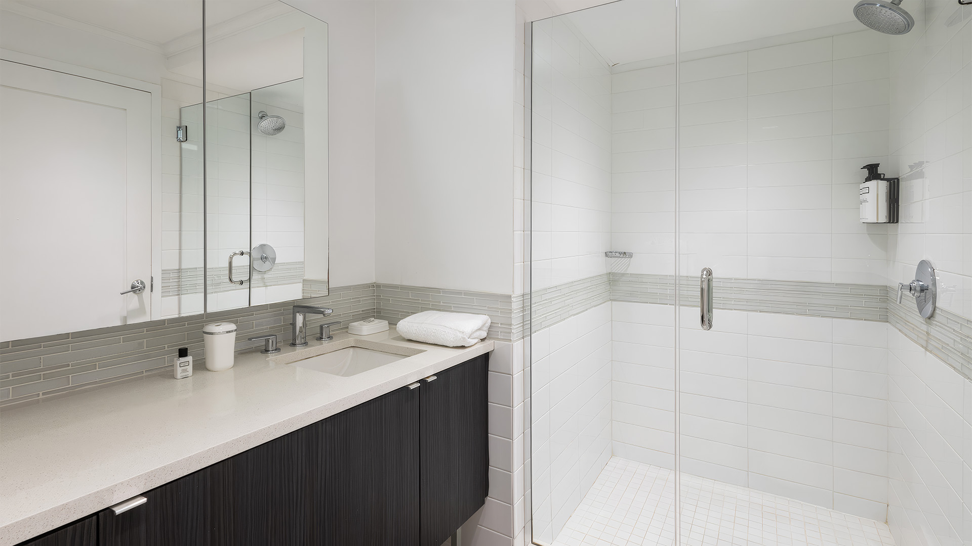 a bathroom with a glass shower and sink