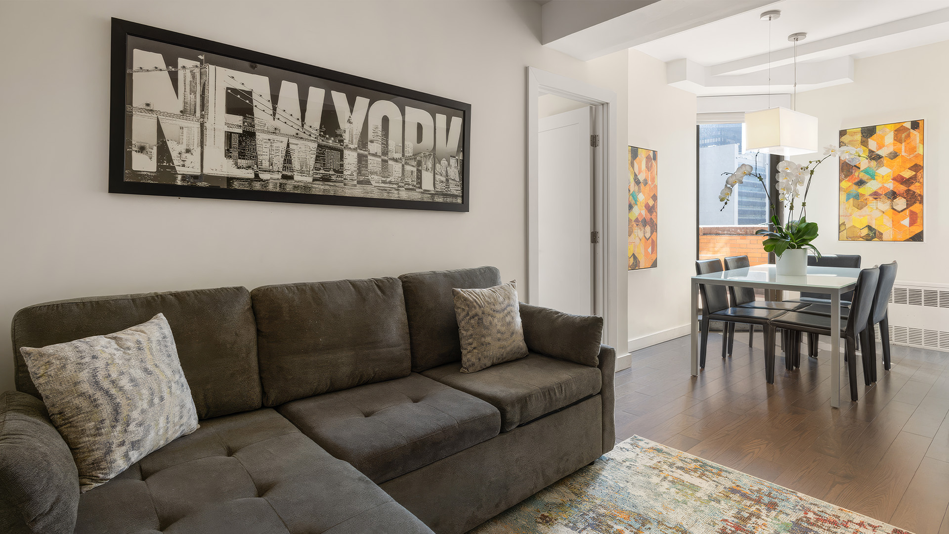 a living room with a couch and a dining table