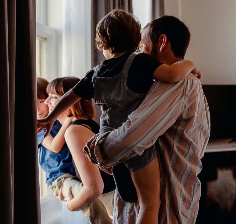 a man holding a child in his arms