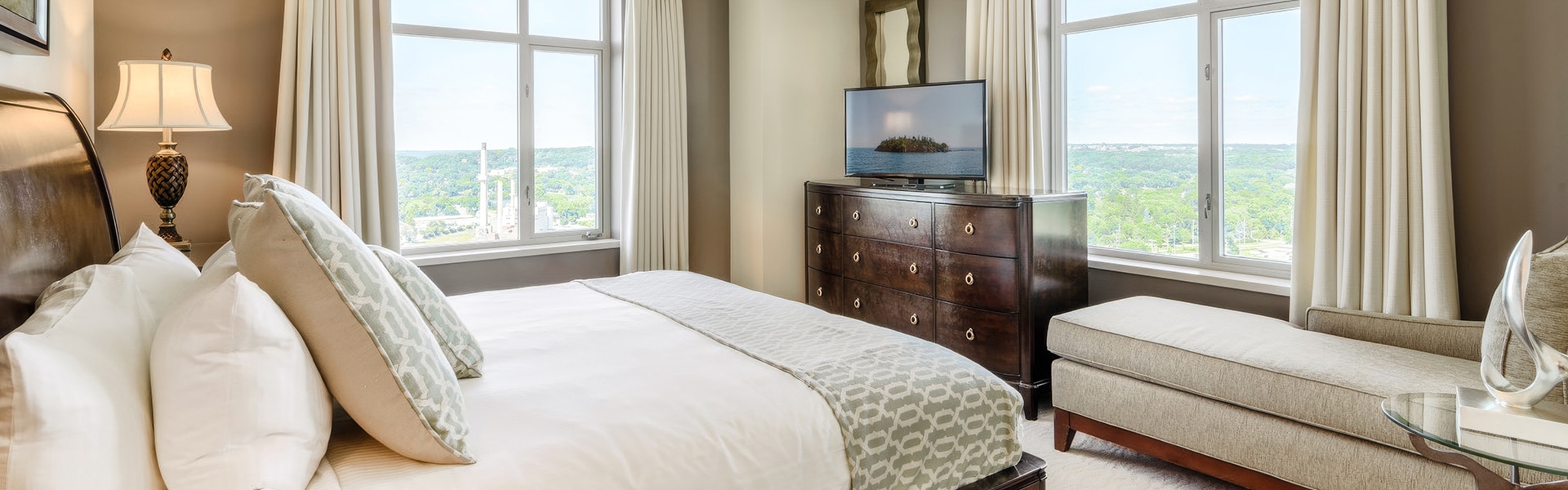 a bedroom with a television on top of a dresser