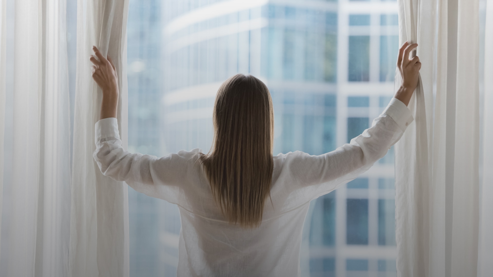 a woman opening a window