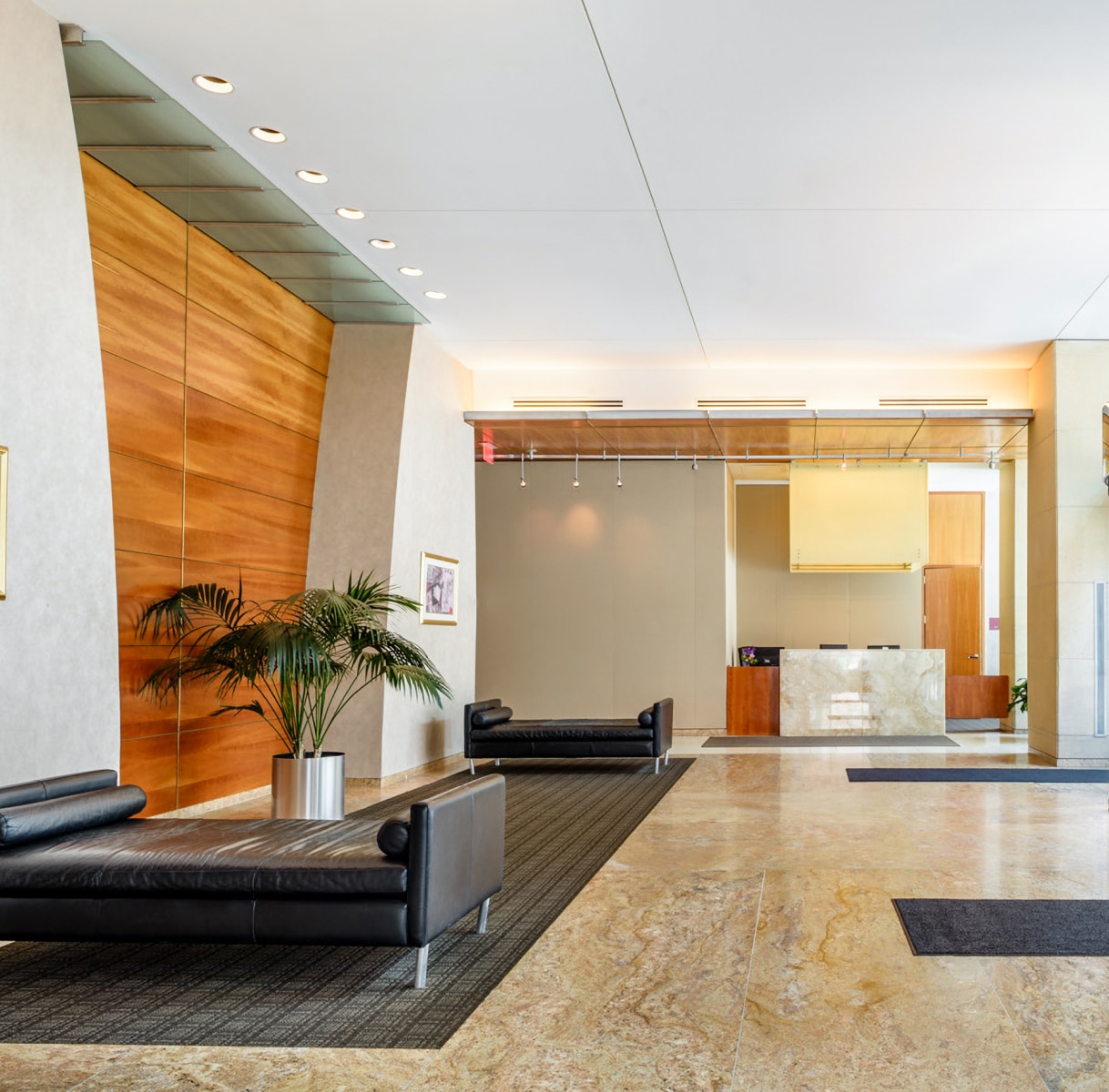 a lobby with a couch and a plant