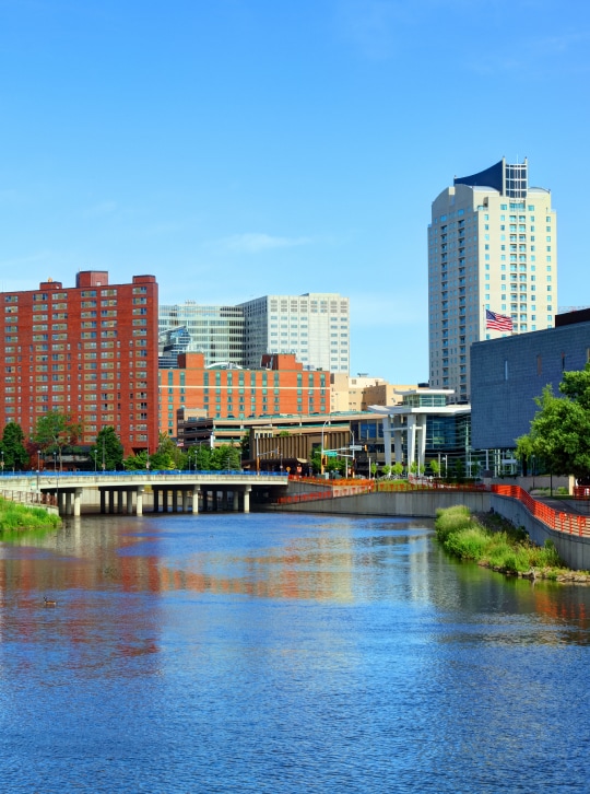 a river with a bridge over a city