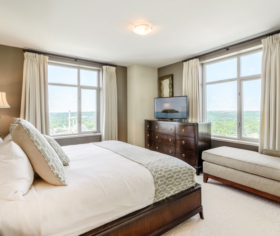 a bedroom with a bed and a television