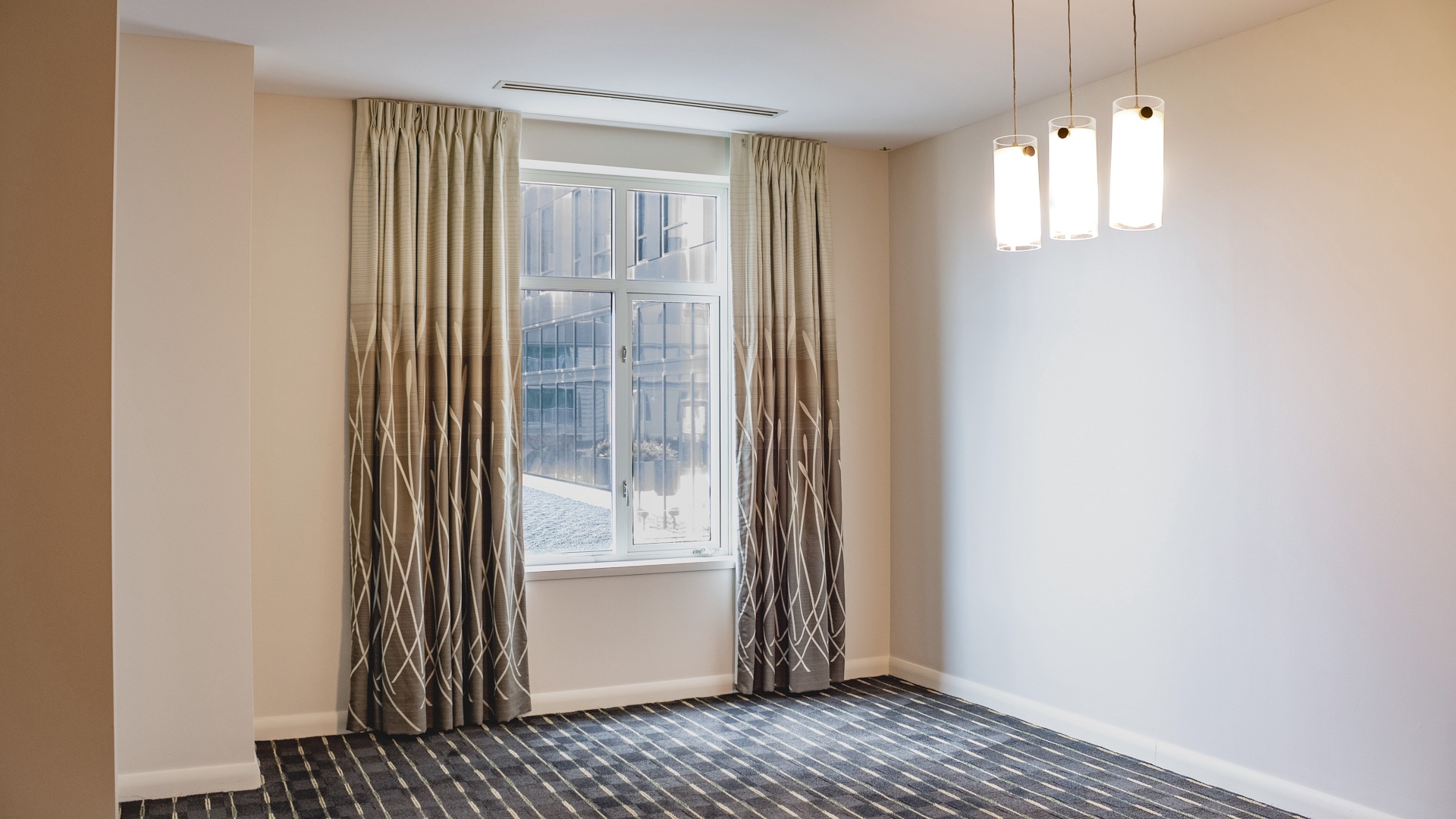 a room with a window and curtains