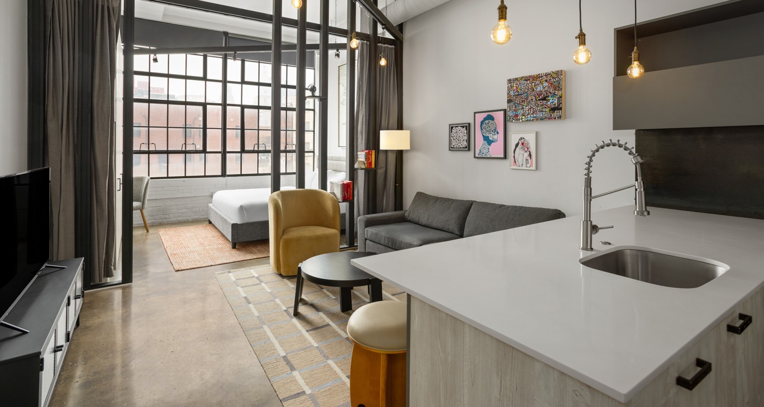 a room with a kitchen and living room