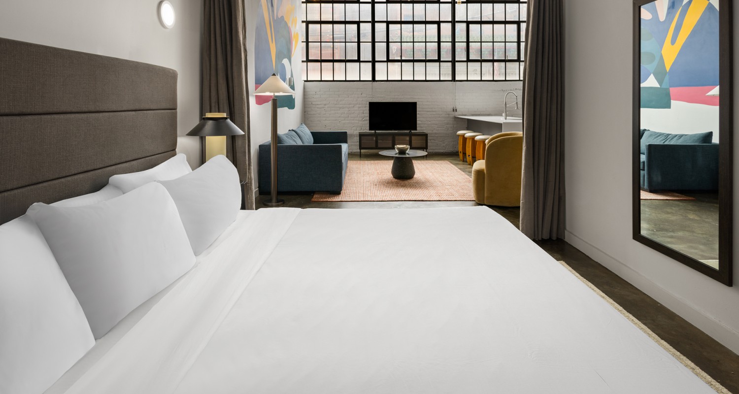 a room with a bed and a couch and a tv