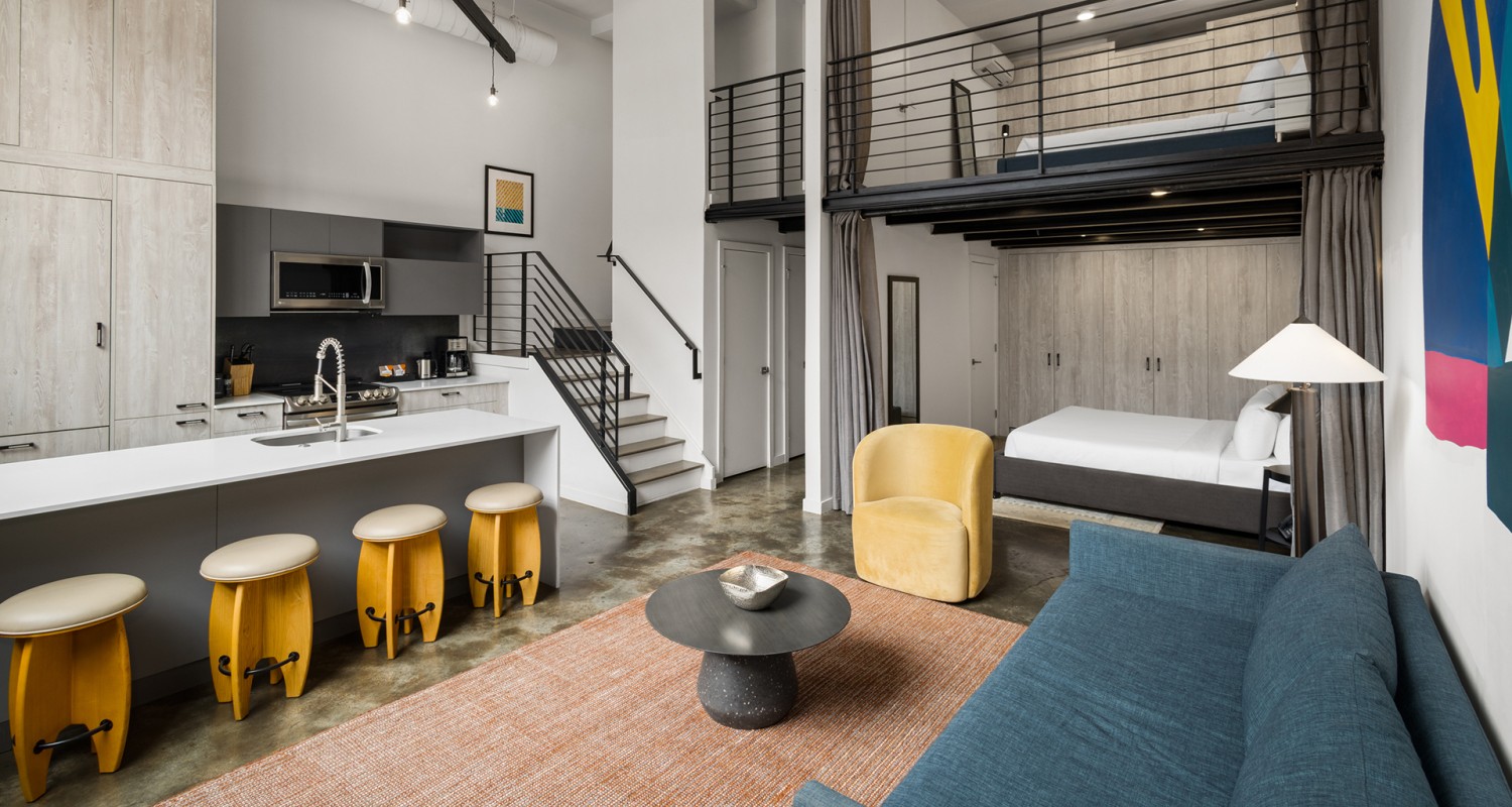 a living room with a loft and a couch