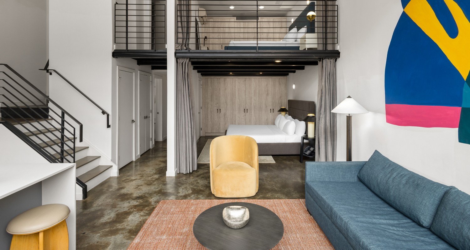 a room with two beds and a sofa