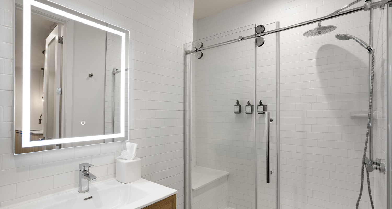 a bathroom with a shower and a mirror